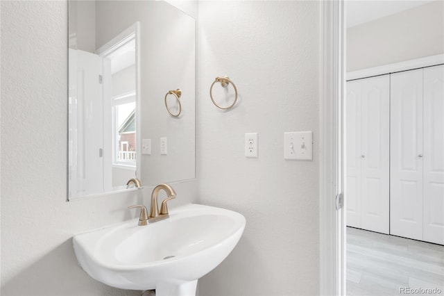 186 S 45th Ave, Brighton, CO 80601 - bathroom with wood finished floors and a textured wall