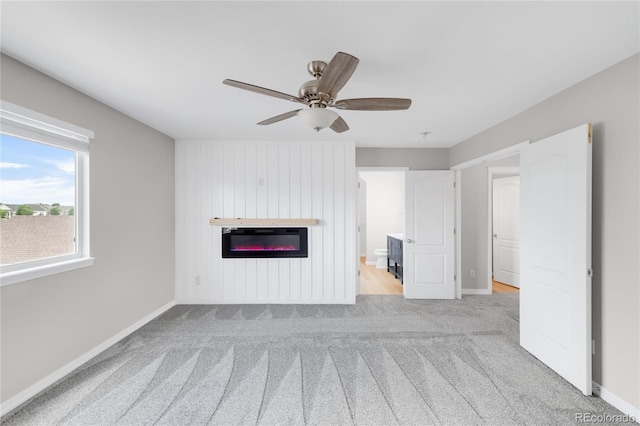 186 S 45th Ave, Brighton, CO 80601 - unfurnished living room featuring carpet flooring, a glass covered fireplace, and ceiling fan