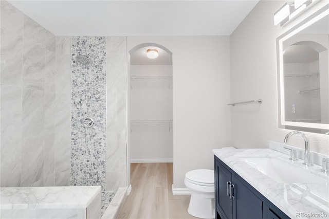 186 S 45th Ave, Brighton, CO 80601 - full bathroom featuring vanity, a walk in shower, a spacious closet, and wood finished floors