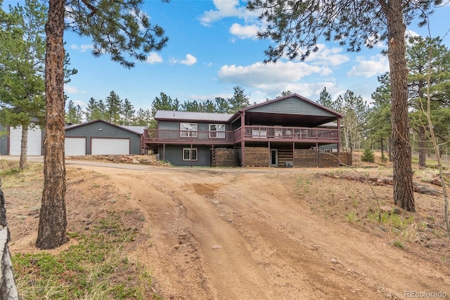 50 Rd P78, Bailey, CO 80421 - view of front facade with a deck, driveway, a garage, and an outdoor structure