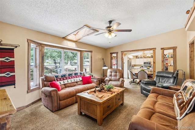 50 Rd P78, Bailey, CO 80421 - carpeted living area with a ceiling fan, a skylight, a textured ceiling, lofted ceiling, and baseboards