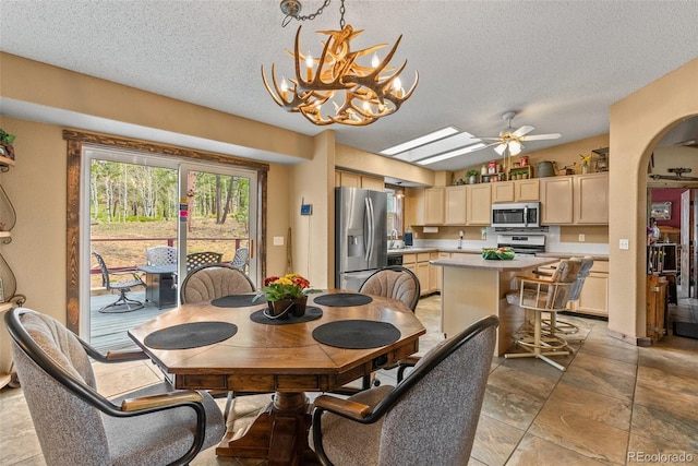 50 Rd P78, Bailey, CO 80421 - dining space featuring a textured ceiling, a chandelier, arched walkways, and a ceiling fan