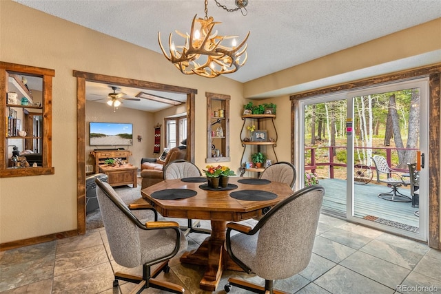50 Rd P78, Bailey, CO 80421 - dining space with lofted ceiling, a chandelier, a textured ceiling, baseboards, and a ceiling fan