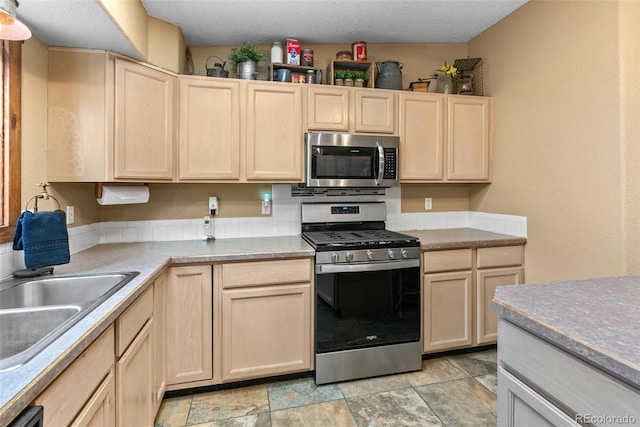 50 Rd P78, Bailey, CO 80421 - kitchen with appliances with stainless steel finishes, light brown cabinets, a sink, and light countertops