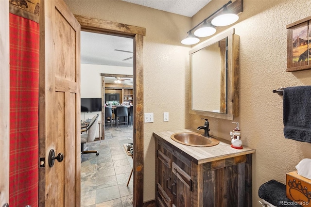 50 Rd P78, Bailey, CO 80421 - bathroom featuring a textured wall, vanity, ceiling fan, and a textured ceiling