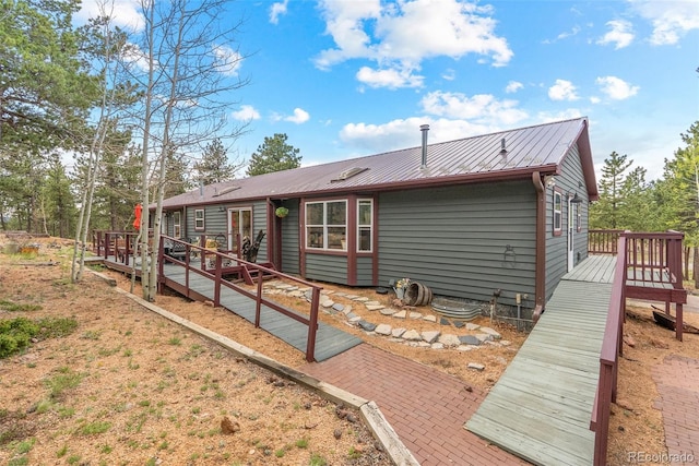 50 Rd P78, Bailey, CO 80421 - view of side of home with a deck and metal roof