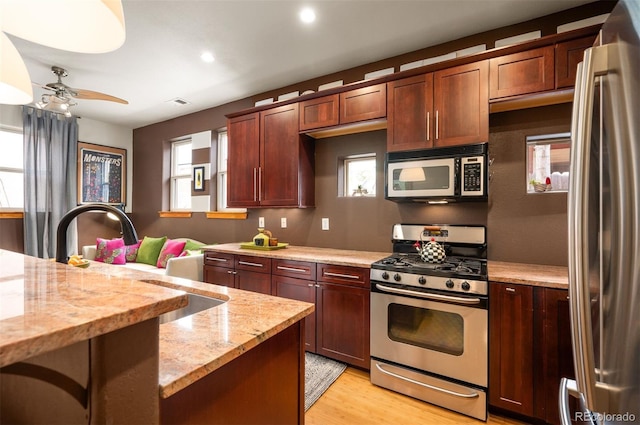 469 Elati St, Denver, CO 80204 - kitchen featuring light stone countertops, appliances with stainless steel finishes, light wood-style floors, a ceiling fan, and recessed lighting