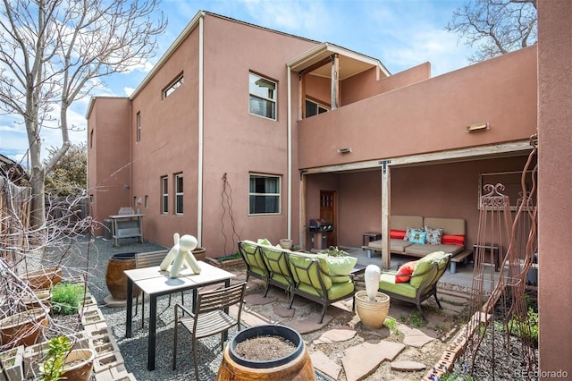 469 Elati St, Denver, CO 80204 - rear view of house with a patio, stucco siding, and an outdoor living space