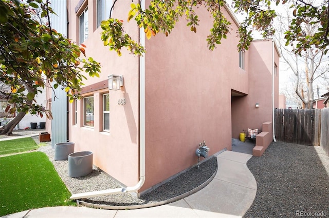 469 Elati St, Denver, CO 80204 - view of property exterior with stucco siding and fence