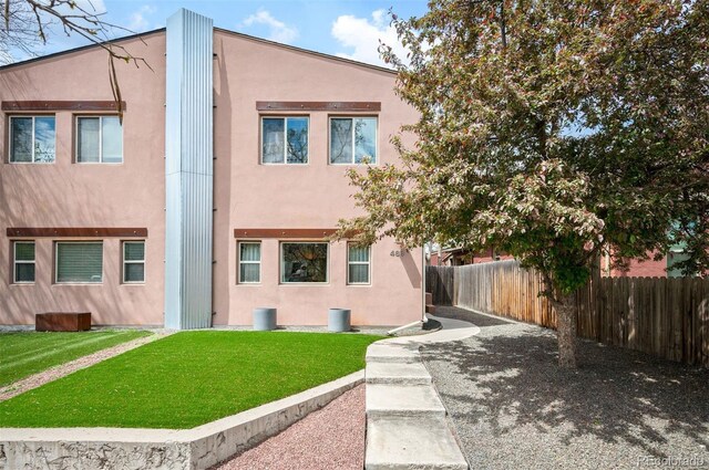 469 Elati St, Denver, CO 80204 - back of house featuring a yard, fence, and stucco siding