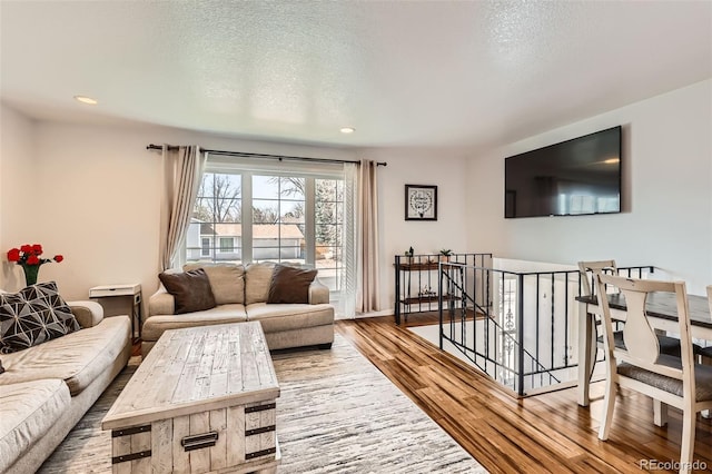 2034 S Idalia St, Aurora, CO 80013 - living area with wood finished floors, recessed lighting, and a textured ceiling