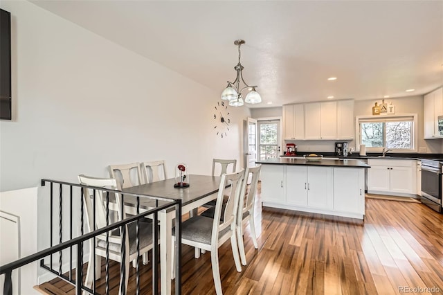 2034 S Idalia St, Aurora, CO 80013 - dining area featuring plenty of natural light, light wood-type flooring, recessed lighting, and a chandelier