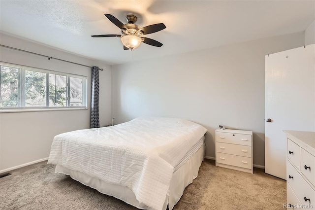 2034 S Idalia St, Aurora, CO 80013 - bedroom with light colored carpet, baseboards, and a ceiling fan