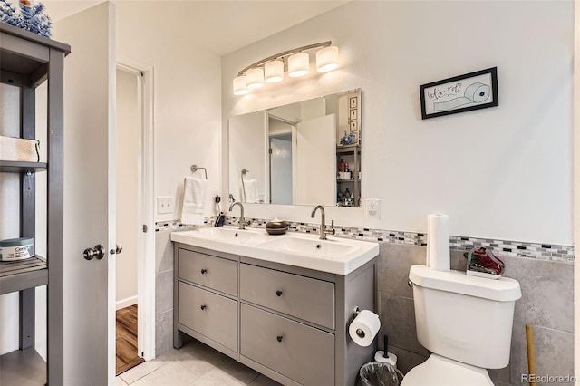 2034 S Idalia St, Aurora, CO 80013 - full bath with double vanity, toilet, tile patterned flooring, and tile walls