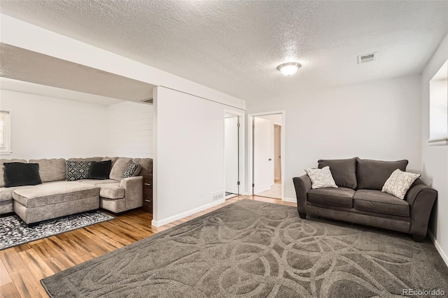 2034 S Idalia St, Aurora, CO 80013 - living room featuring wood finished floors, a textured ceiling, and baseboards