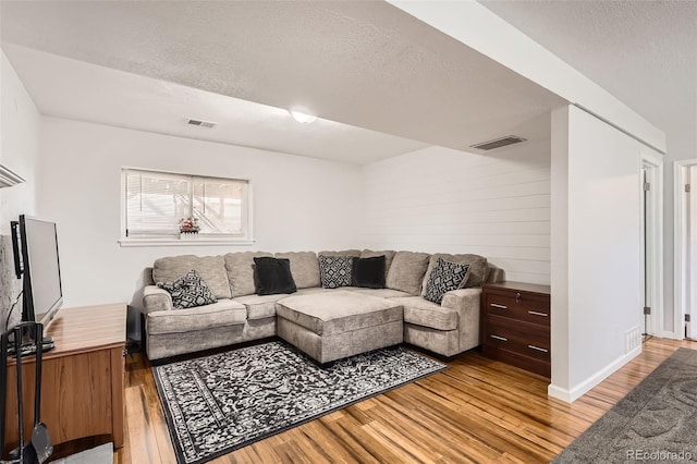 2034 S Idalia St, Aurora, CO 80013 - living area featuring light wood-type flooring, a textured ceiling, and baseboards