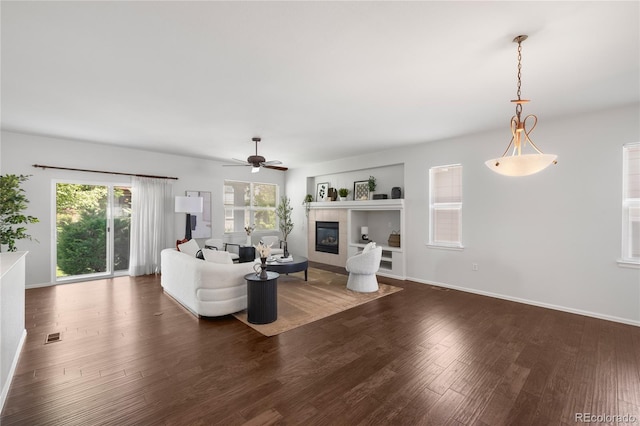 23421 E Long Pl, Aurora, CO 80016 - living room with dark wood finished floors, a ceiling fan, and a fireplace