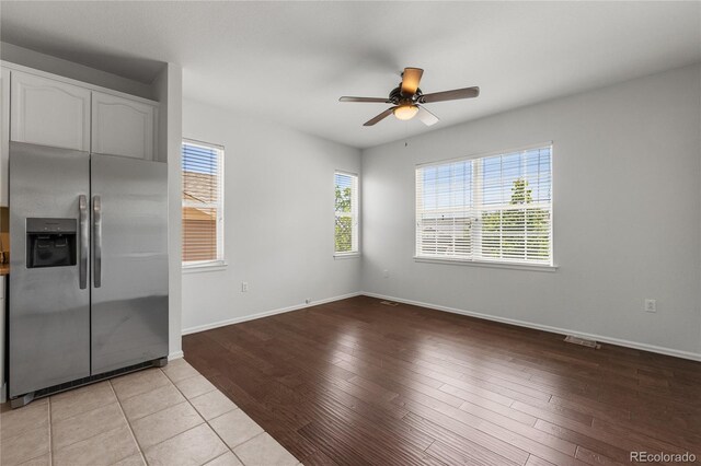 23421 E Long Pl, Aurora, CO 80016 - kitchen featuring stainless steel refrigerator with ice dispenser, white cabinetry, ceiling fan, and light wood finished floors