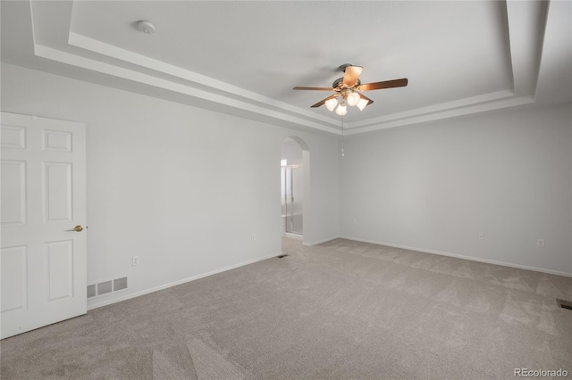 23421 E Long Pl, Aurora, CO 80016 - carpeted spare room featuring a raised ceiling, ceiling fan, and arched walkways