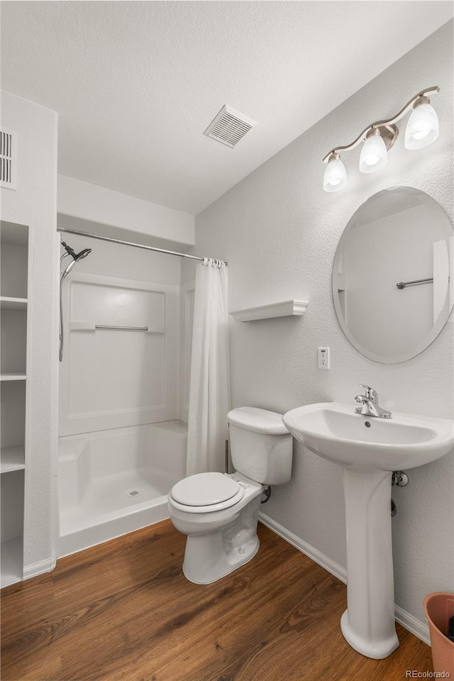 23421 E Long Pl, Aurora, CO 80016 - bathroom with a stall shower, wood finished floors, and a textured ceiling
