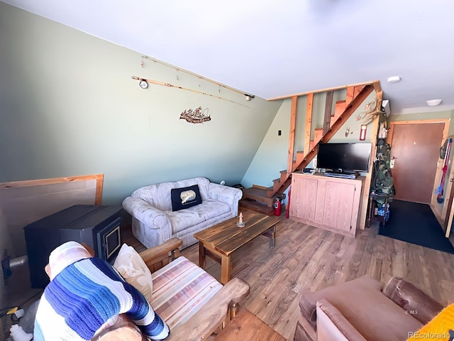 living room with hardwood / wood-style flooring and vaulted ceiling