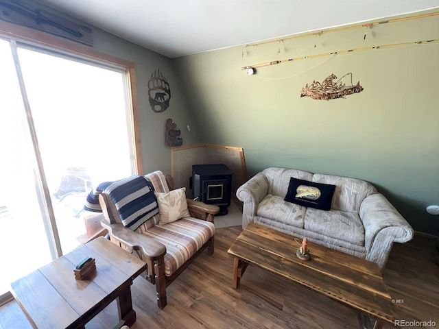 living room with a wood stove and hardwood / wood-style floors