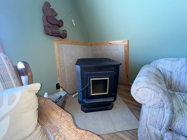 interior details with a wood stove and hardwood / wood-style flooring