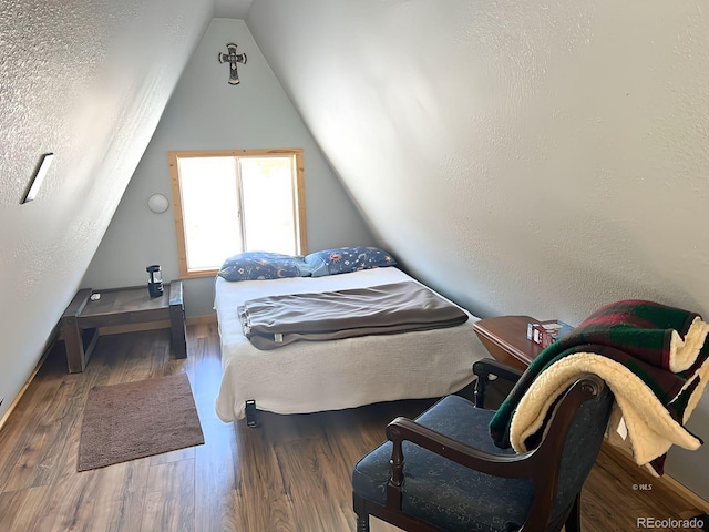 bedroom featuring vaulted ceiling and dark hardwood / wood-style flooring