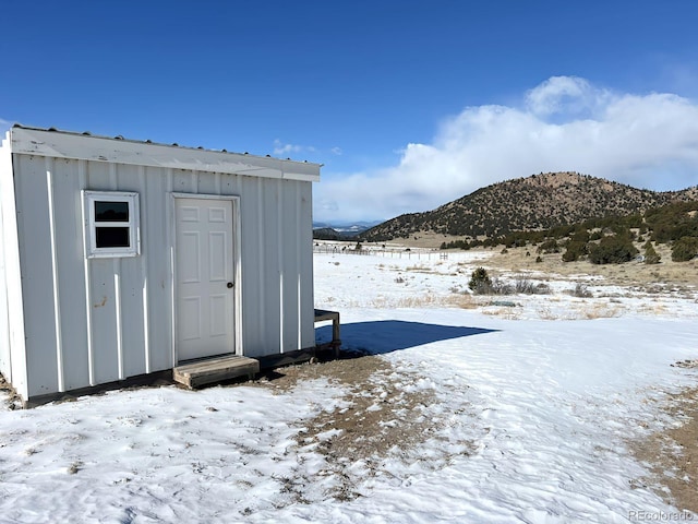 snow covered structure with a mountain view