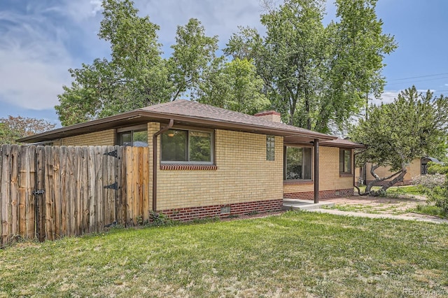 5600 Dover St, Arvada, CO 80002 - view of property exterior with crawl space, a chimney, and brick siding