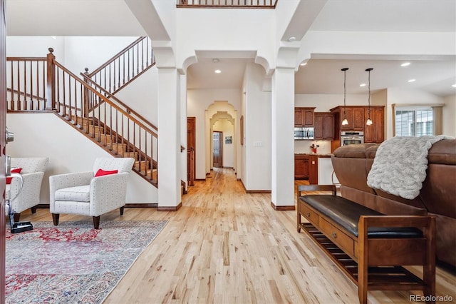 foyer featuring a high ceiling and light hardwood / wood-style floors