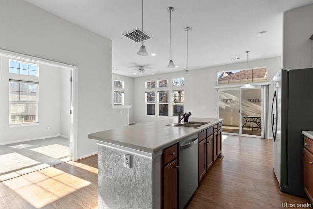 kitchen with visible vents, pendant lighting, appliances with stainless steel finishes, dark wood-style floors, and a sink