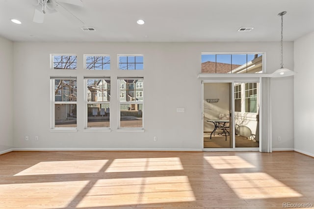 spare room featuring visible vents, recessed lighting, baseboards, and wood finished floors