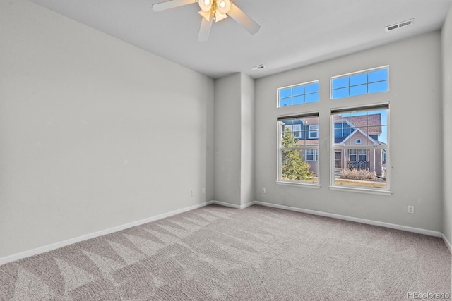 unfurnished room featuring visible vents, ceiling fan, baseboards, and carpet floors