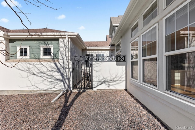 view of side of home with a gate