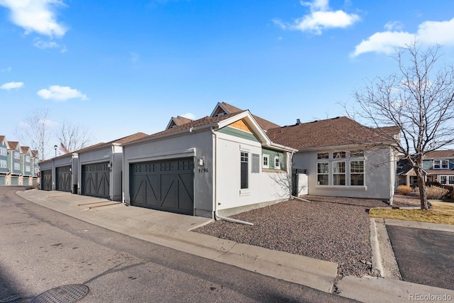 view of front of house with community garages and stucco siding