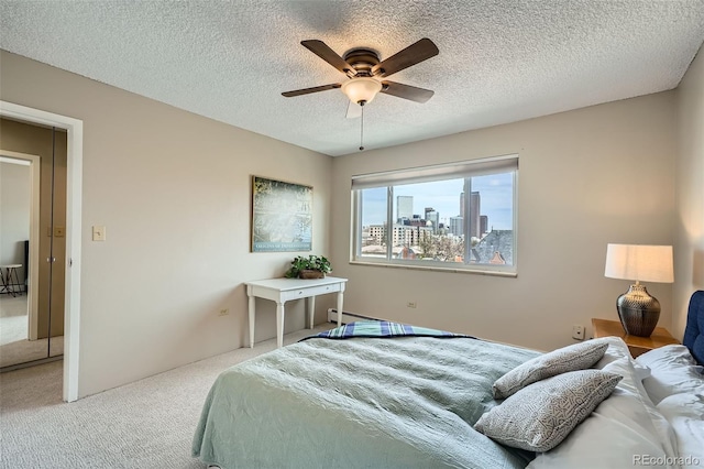 1045 N Pennsylvania St Unit 601, Denver, CO 80203 - carpeted bedroom featuring a textured ceiling, a ceiling fan, and a city view