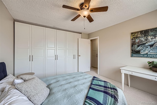 1045 N Pennsylvania St Unit 601, Denver, CO 80203 - bedroom featuring light colored carpet, a textured ceiling, and a ceiling fan