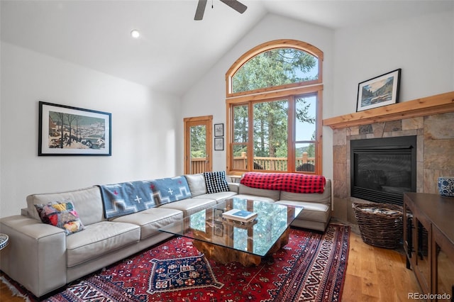 27711 Moffat Rd, Evergreen, CO 80439 - living area featuring ceiling fan, wood finished floors, high vaulted ceiling, and a tile fireplace