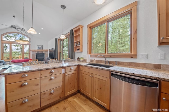 27711 Moffat Rd, Evergreen, CO 80439 - kitchen featuring light stone countertops, dishwasher, a sink, a peninsula, and light wood-style floors