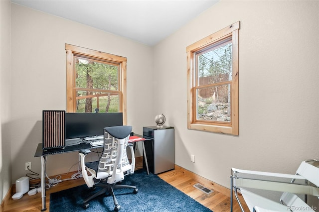 27711 Moffat Rd, Evergreen, CO 80439 - home office featuring baseboards, plenty of natural light, wood finished floors, and visible vents
