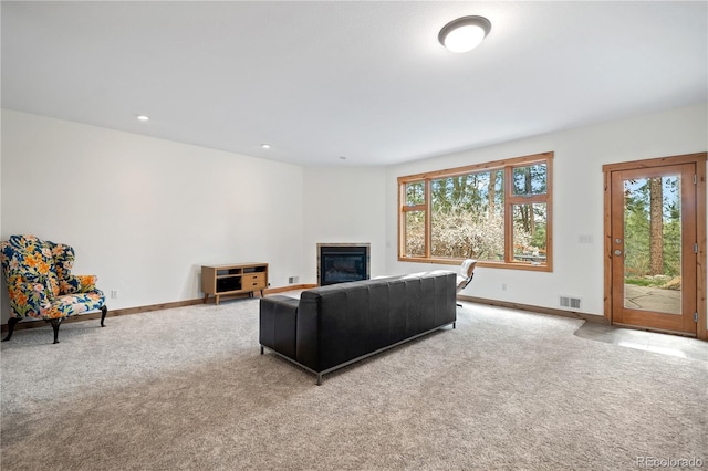27711 Moffat Rd, Evergreen, CO 80439 - living area with baseboards, visible vents, a glass covered fireplace, and carpet