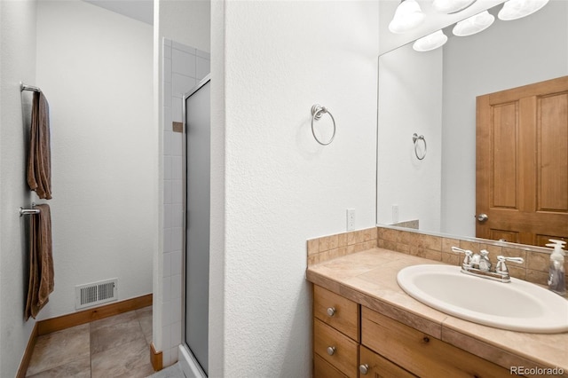 27711 Moffat Rd, Evergreen, CO 80439 - bathroom featuring visible vents, baseboards, vanity, and a shower stall