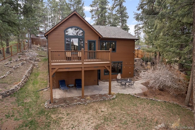27711 Moffat Rd, Evergreen, CO 80439 - rear view of property featuring a deck, a patio area, fence, a yard, and a shingled roof