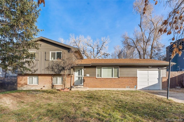 split level home with a garage and a front lawn