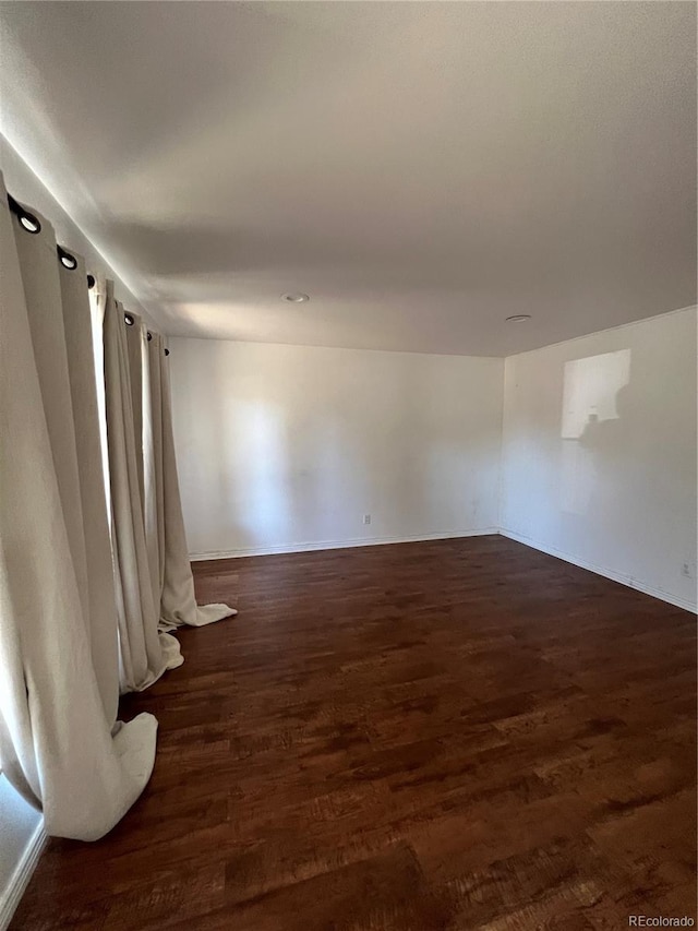 unfurnished room featuring dark hardwood / wood-style flooring