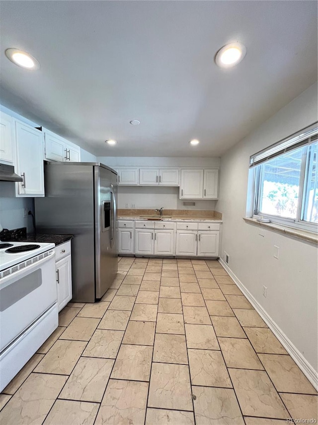 kitchen with white cabinetry, white electric range, sink, and stainless steel fridge