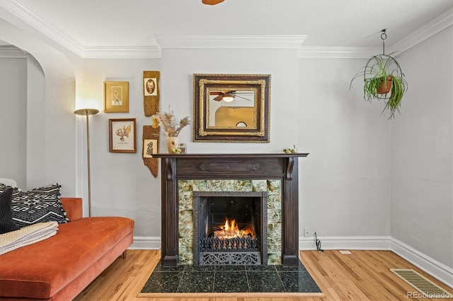 sitting room featuring ornamental molding, hardwood / wood-style floors, and a high end fireplace