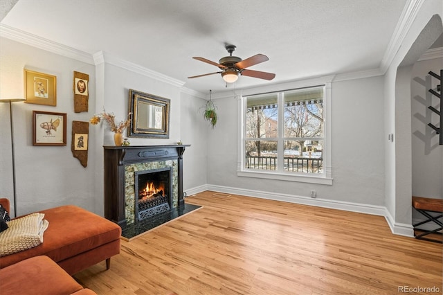 sitting room featuring ornamental molding, ceiling fan, and light hardwood / wood-style floors