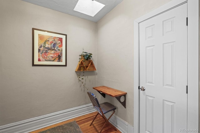 office featuring a skylight and wood-type flooring